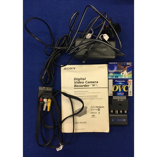 386 - A Sony DCR-TRV30E Digital Video Camera. Complete with case, charger instructions, battery & 2 unopen... 