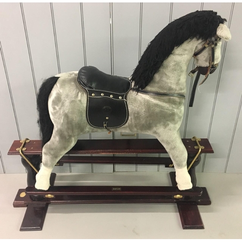 253 - A vintage cushioned rocking horse. 