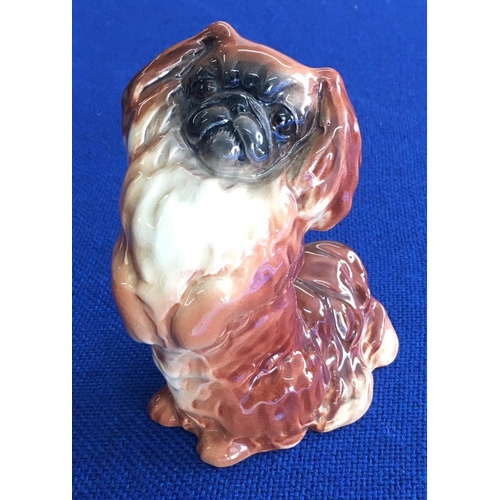 314 - A Beswick Pekinese dog, in begging pose.
Height 12cm Length 9cm