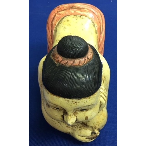 566 - A solid wood crouching figure/pillow.
Dimensions(cm) H 32 W44 D20