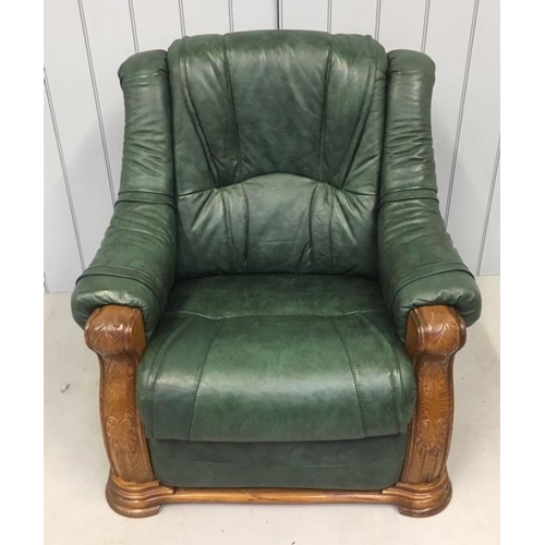 580 - A quality green leather suite, with oak surround. A two seater sofa and two armchairs. Each is a rec... 