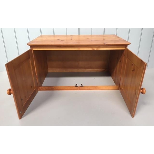 617 - A small pine unit made to sit upon another piece of furniture. 2-door with a hollow base.
Dimensions... 