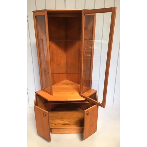 644 - A mid-century teak corner display cabinet by Turnidge of London. A glass doored, 2 shelved, display ... 