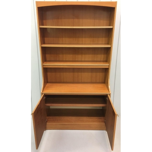 655 - A tall bookcase/cupboard made by Schreiber c.1970's.
3 shelves above a single-shelved two-door cupbo... 