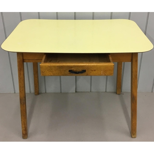 242 - A retro Formica kitchen table.
Yellow Formica table-top above a single drawer, sitting on splayed le... 