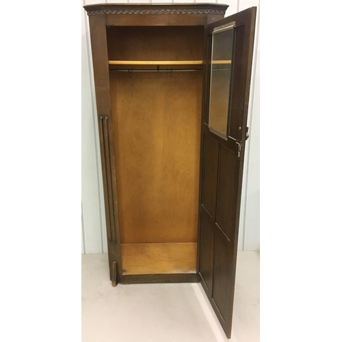 703 - An early 1900's oak wardrobe.
Single internal shelf, with internal mirror and hanging rail.
Dimensio... 