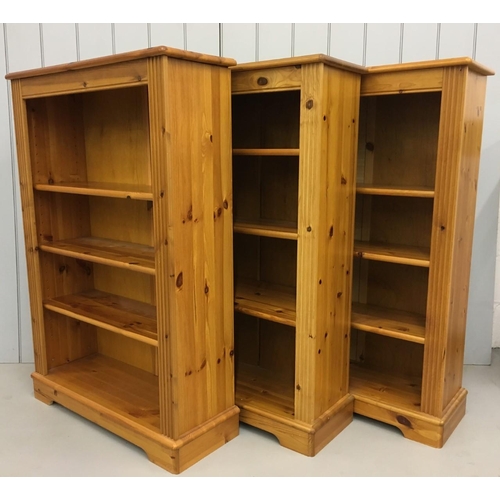 246 - A trio of matching medium sized, pine, open bookcases. Each having three adjustable shelves. Two fur... 