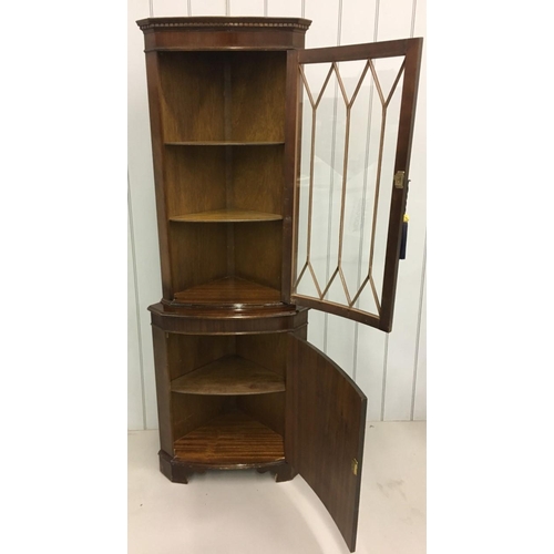 704 - A tall mahogany corner/display cabinet.
Edwardian-style glass door above bow-fronted cupboard. Key p... 