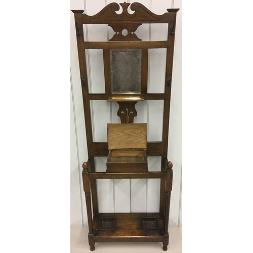 585 - An oak Hall Stand with bevelled mirror and original hooks.
Dimensions(cm) H188 W69 D27