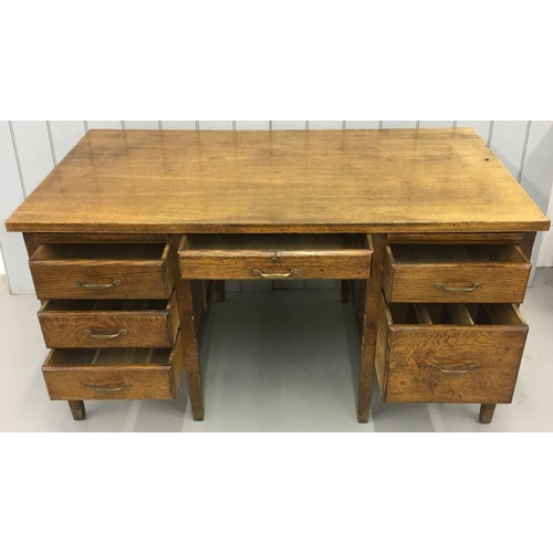 568 - A substantial, early 20th century Oak desk. Twin drawered pedestals with a total of six drawers and ... 