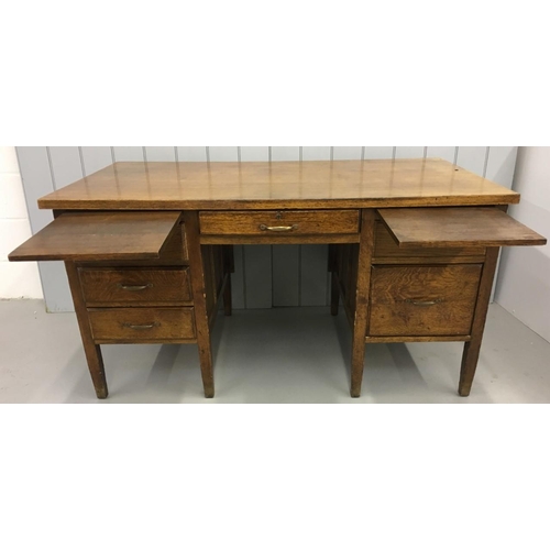 568 - A substantial, early 20th century Oak desk. Twin drawered pedestals with a total of six drawers and ... 