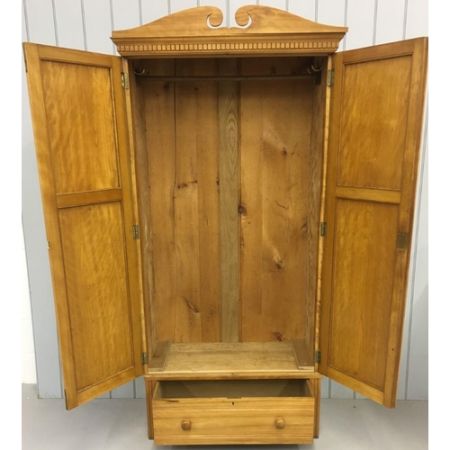 658 - A heavy satinwood wardrobe. Single drawer with brass hanging rail and hooks. Key present. Believed t... 