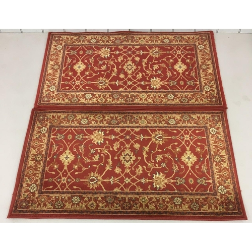 707 - A pair of short, burgundy patterned rugs.
Length 115cm Width 68cm