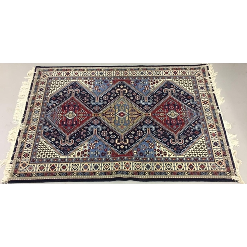 708 - A large, fringed wool rug, with blue, burgundy & cream pattern.
Length 200cm Width 127cm