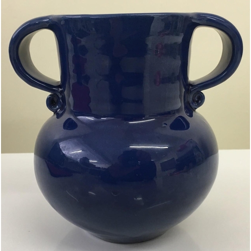 143 - An early 1900's blue glazed pottery vase by Liberty.
Twin handled. Liberty marking impressed to base... 