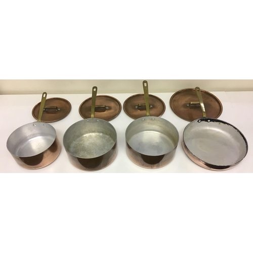 689 - A set of three vintage copper saucepans, together with a matching copper frying pan.