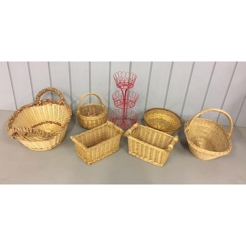 710 - A mixed lot of wicker baskets and one other stand.