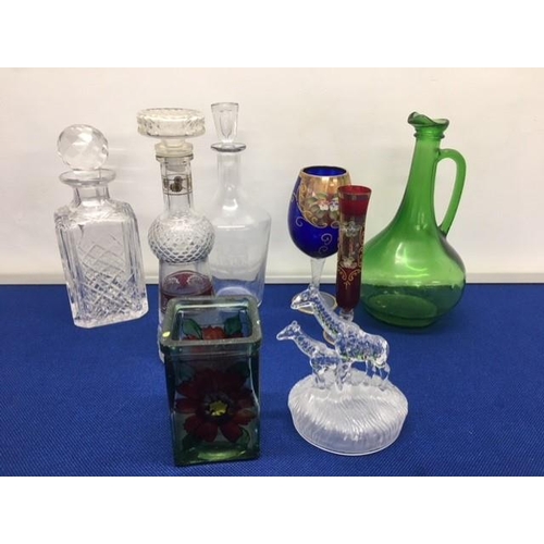 247 - A mixed lot of eight pieces of glassware.
Includes decanters, Giraffe ornament, goblet, vases etc.