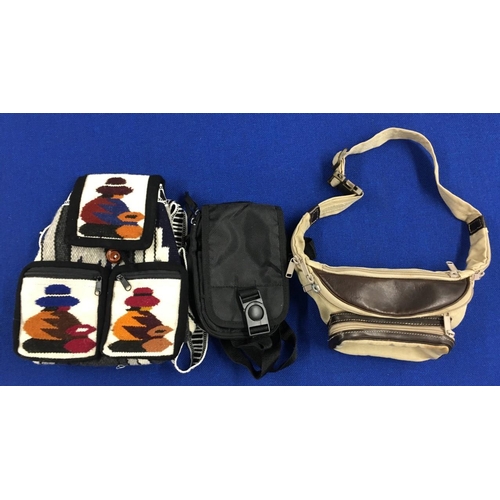 558 - An original leather bum-bag, together with another and an authentic Peruvian Rucksack