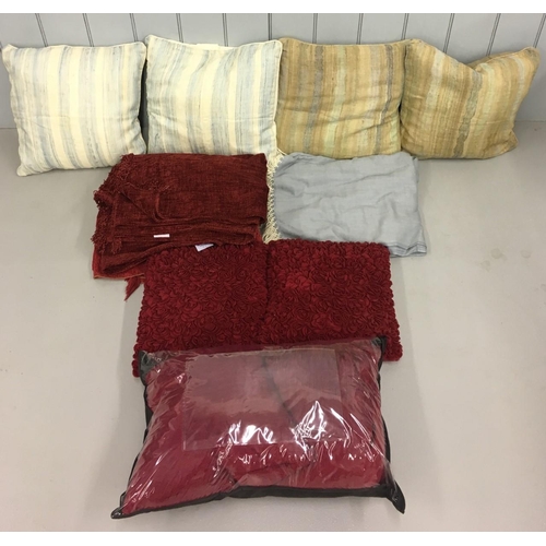 554 - A mixed lot of soft furnishings. Includes four striped cushions, two burgundy frilled cushions, two ... 