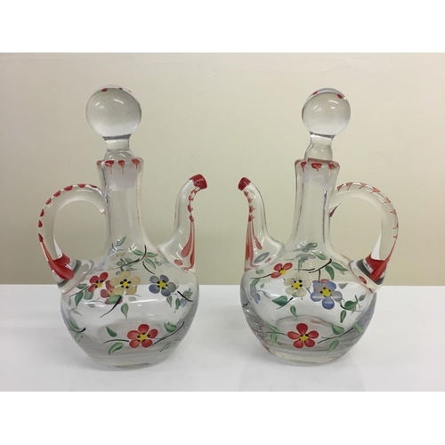 592 - A pair of hand painted, decorative, glass pitchers. Floral design.
15cm tall