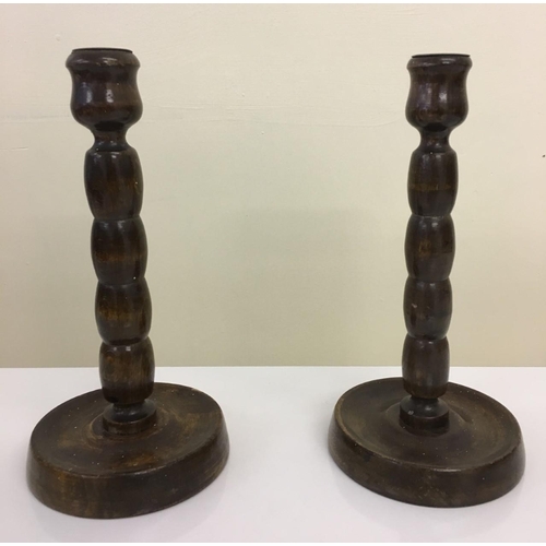560 - A vintage pair of wooden candleholders.
21cm tall.