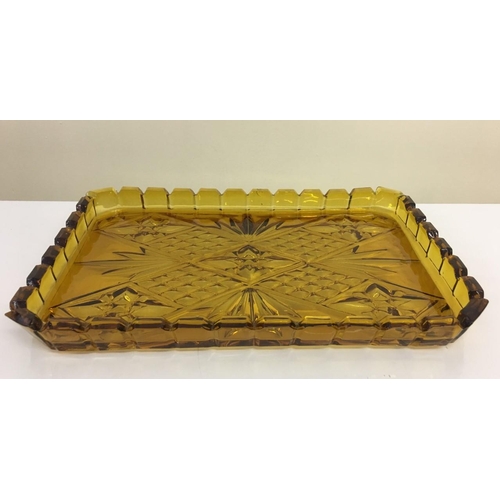 601 - An early Amber glass Dressing Table set. Includes tray, ring holder & three lidded trinket pots (2 s... 