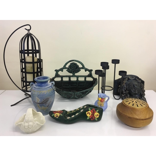 552 - A selection of nine pieces of homeware. Includes candleholders, plant holders, vases, doorstop etc.