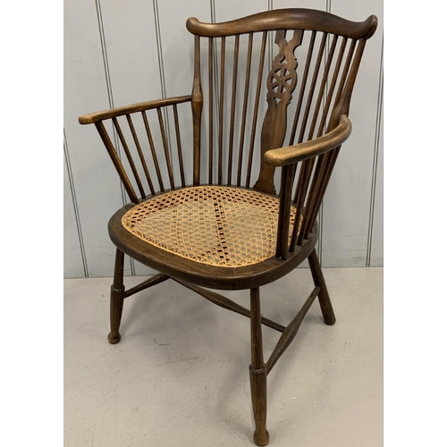 148 - An oak,  Windsor, wheel-backed carver chair, with cane seat.
Dimensions(cm) H80 (37 to seat), W56, D... 