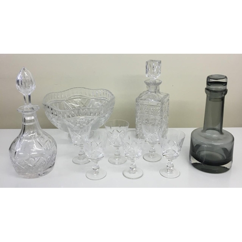 241 - A mixed lot of crystal glassware. Includes three vintage decanters (two crystal, one smoked glass), ... 