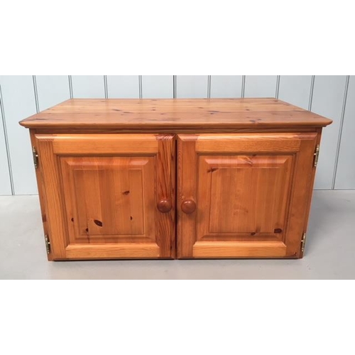 110A - A small pine unit made to sit upon another piece of furniture. Two-door with a hollow base. Dimensio... 
