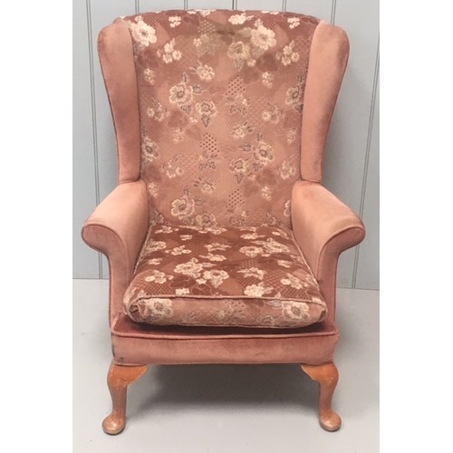 153 - A classic Parker Knoll winged Armchair. Model PK 720. The chair comes with check fabric covers also.... 