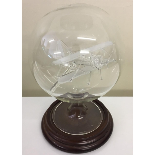 207 - An ornamental glass Bi-plane in glass dome, on stand.
Height 20cm