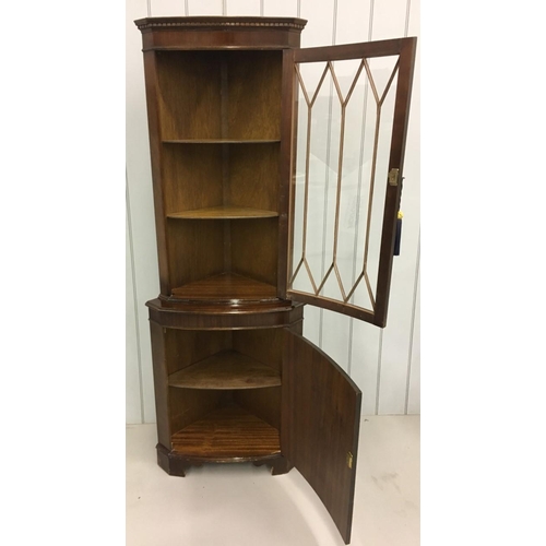 33 - A tall mahogany Corner Display Cabinet.
Edwardian-style glass door above bow-fronted cupboard. Key p... 