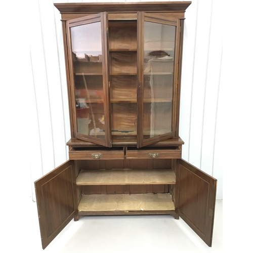 35 - A tall, Edwardian Library Bookcase. Three-shelved, glazed cupboard over two drawers, over twin cupbo... 