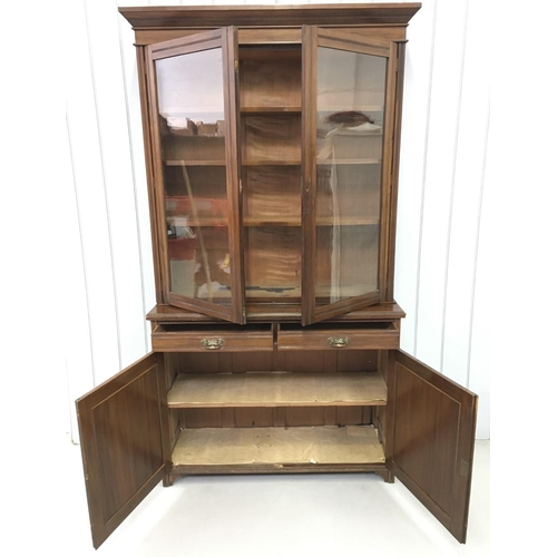 28 - A tall, Edwardian Library Bookcase. Three-shelved, glazed cupboard over two drawers, over twin cupbo... 