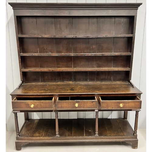 44 - An antique oak dresser. Base fitted with three frieze drawers raised on turned supports. Upper fitte... 