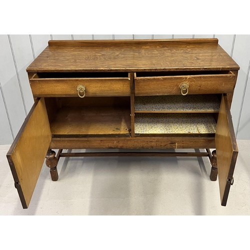 62 - An Edwardian, oak Buffet Sideboard. Two drawers, over single-shelved double cupboard, upon stretcher... 