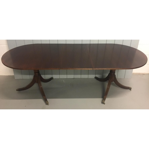 8 - An extending, large classic Dining Table.
Oval shaped, on twin pedestal legs and brass castors. Exte... 