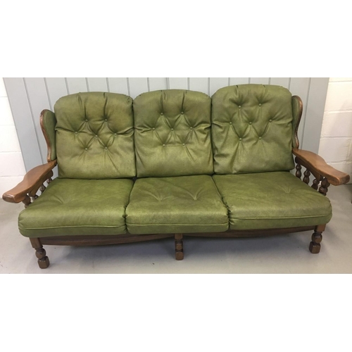 172 - A vintage Oak-framed, green, faux leather suite. Three seater sofa, with armchair and rocking armcha... 