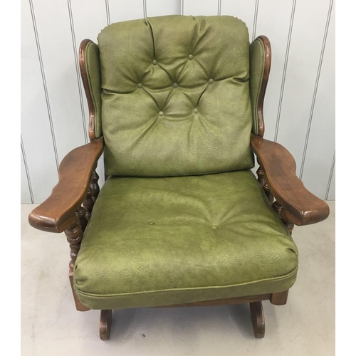 172 - A vintage Oak-framed, green, faux leather suite. Three seater sofa, with armchair and rocking armcha... 