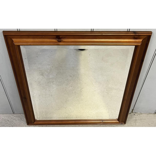 250 - A dark-pine, bevelled-edged, framed mirror.
74cm x 62cm