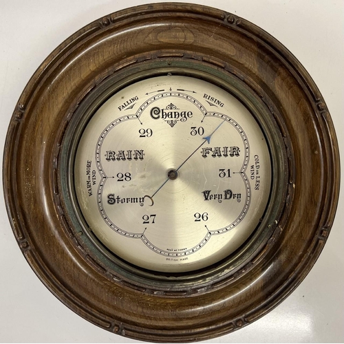 394 - A British made, antique oak wheel barometer. Reg. no. 710284.
Diameter 29cm