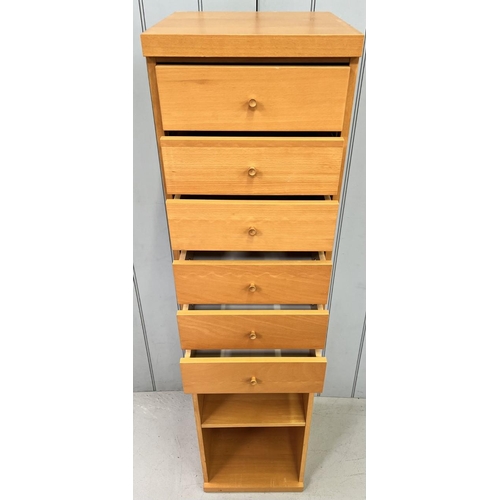 75 - A narrow, beech coloured, tallboy chest of six drawers, with single shelved area beneath.. Dimension... 