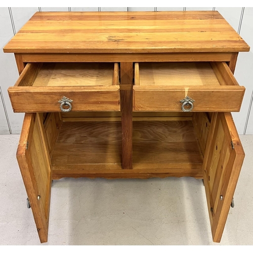 127 - A narrow, pine kitchen sideboard. Two drawers, over two-door cupboard. Dimensions(cm) H80 W92 D46.