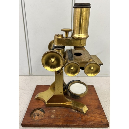 323A - A 19th century, cased, brass microscope.