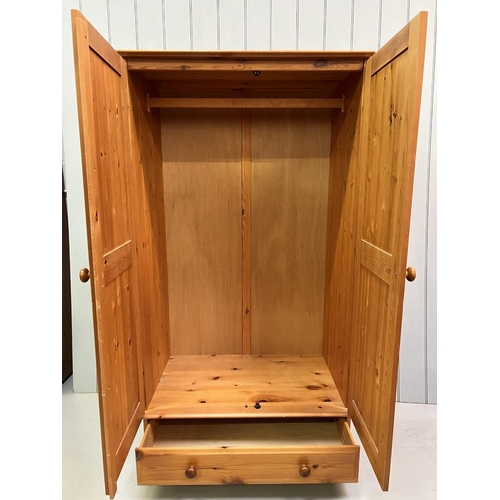 61 - A pine double wardrobe with single floor level drawer, hanging rail and bun feet.
Dimensions(cm): H1... 