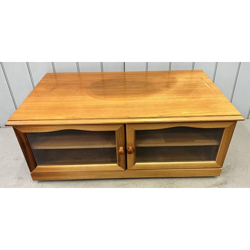 129 - A teak/glazed TV cabinet, on castors, by James H Sutcliffe & Sons. Dimensions(cm) H40 W100, D57.