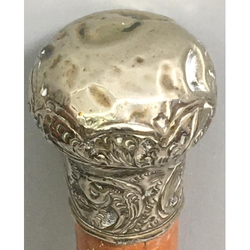 420 - A silver-topped cane. No visible hallmark.