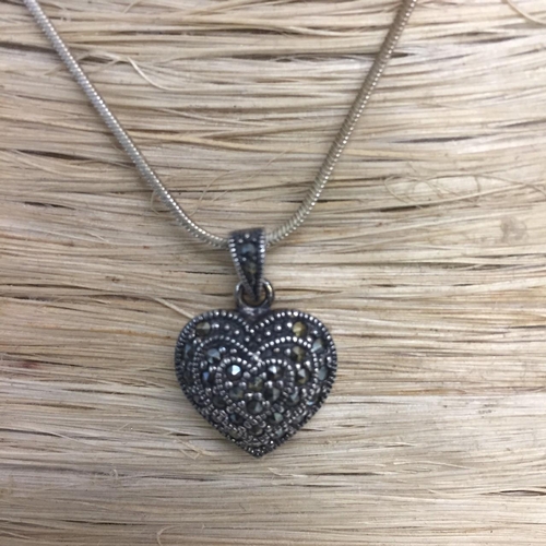 423 - A vintage silver heart pendant, marked '925', together with a white metal chain.